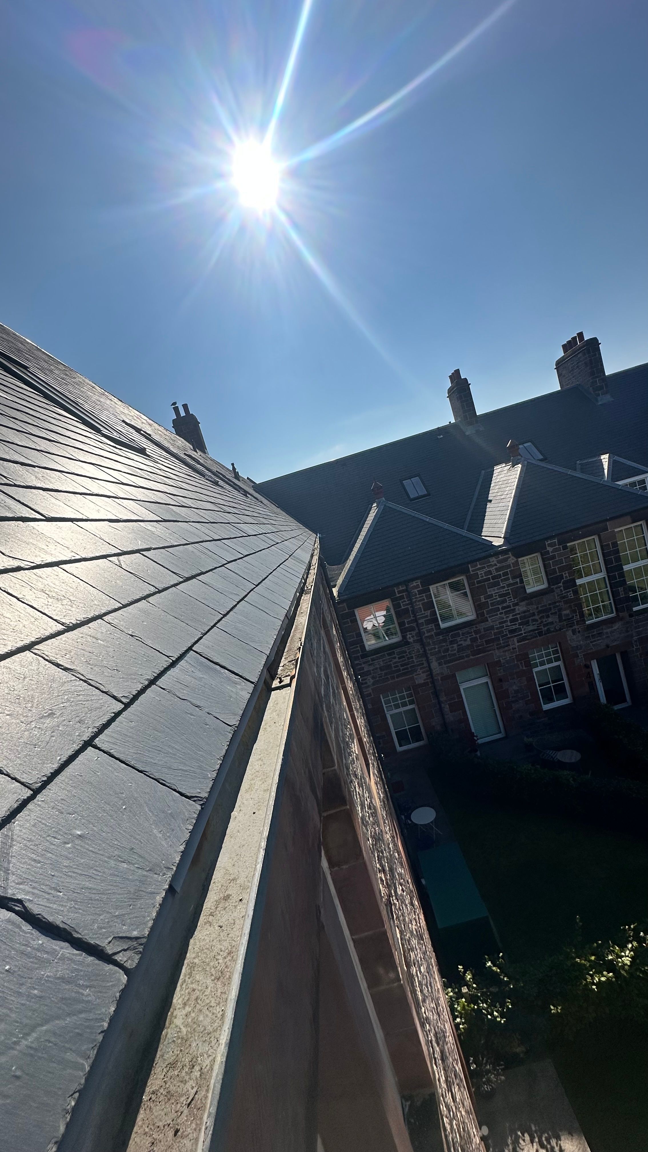 Slate roof and lead guttering in sunshine - Meta Trade Solutions Edinburgh